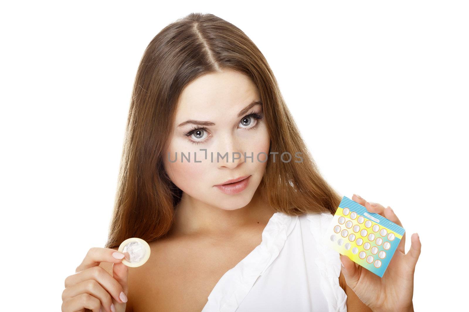 Pretty girl with condom and contraceptive pills. by Nobilior