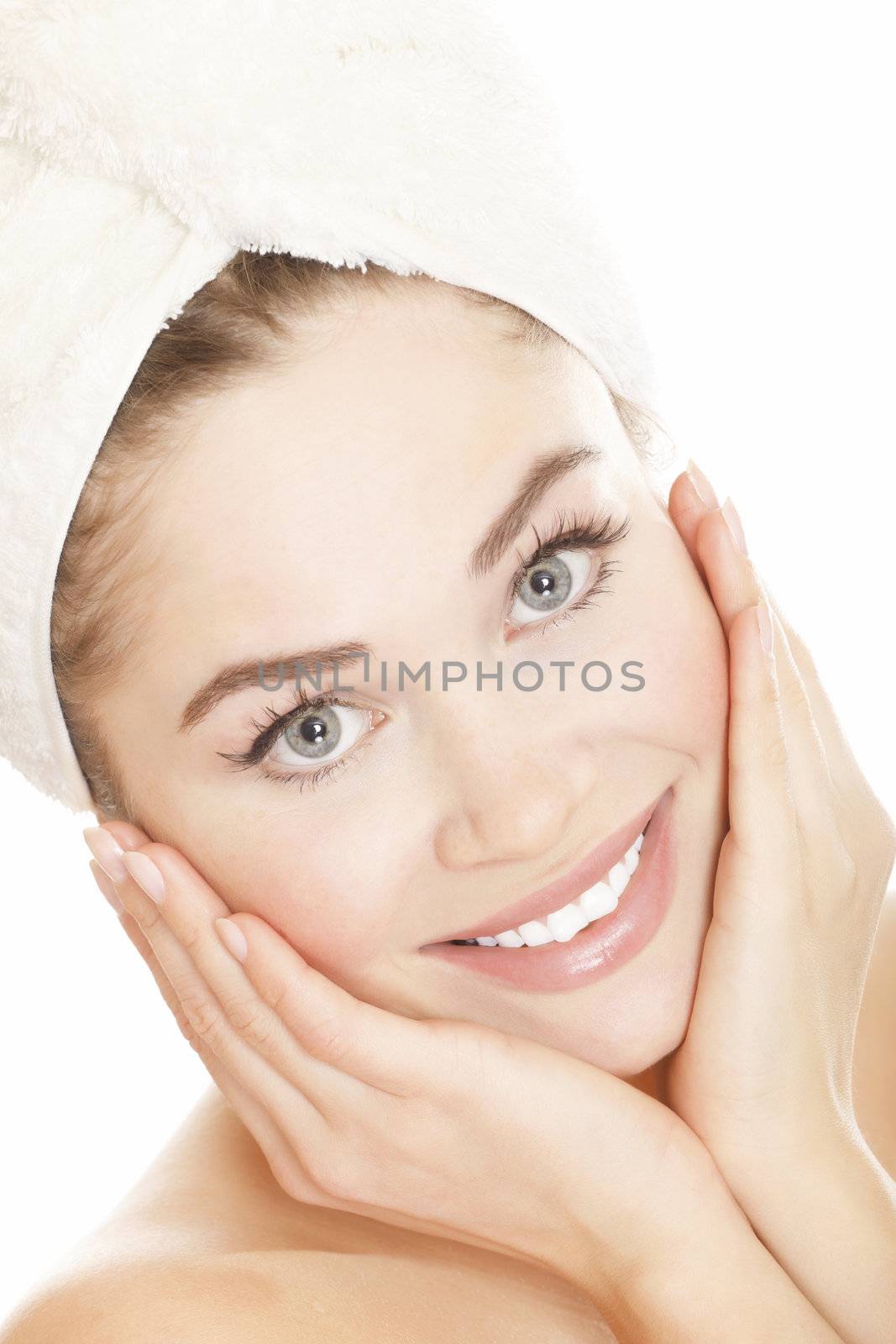 Beautiful young woman face with white towel on the head, isolated on white background