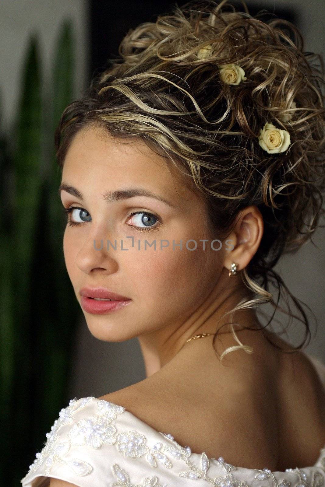 Portrait of beautiful young adult woman bride looking over shoulder.