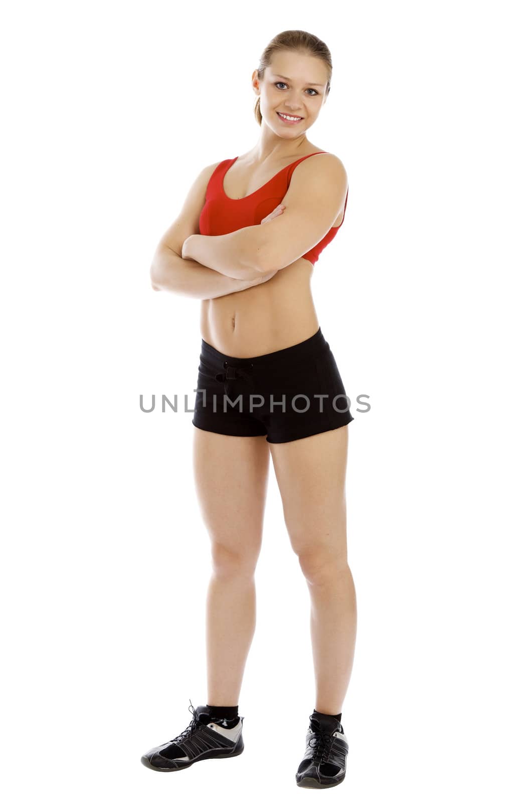 Smiling young sporty woman. Isolated over white background.