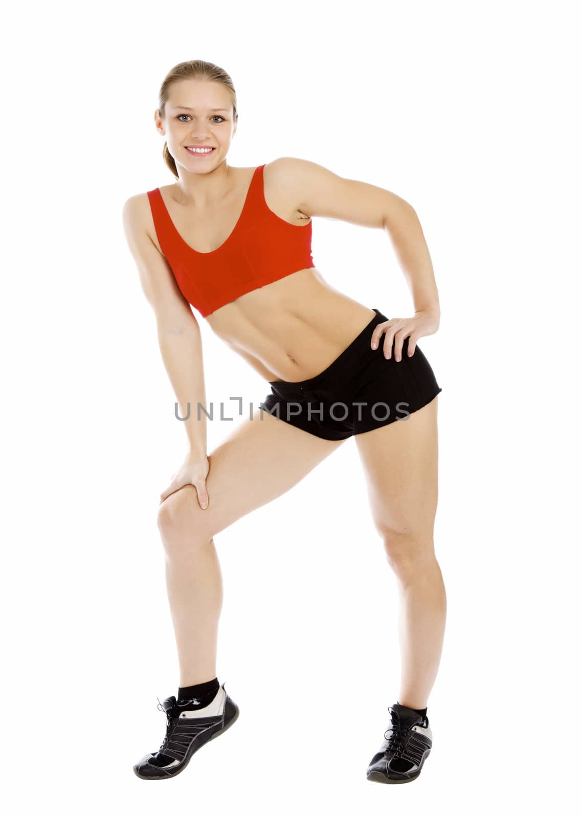 Smiling young sporty muscular woman. Isolated over white background