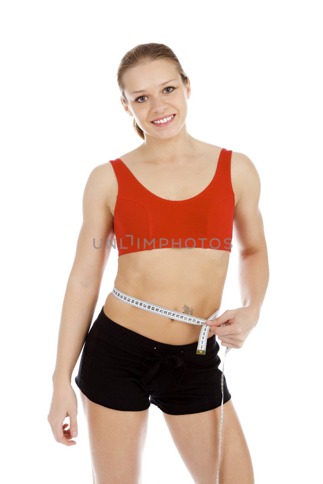 Sport woman with measuring tape posing against white background