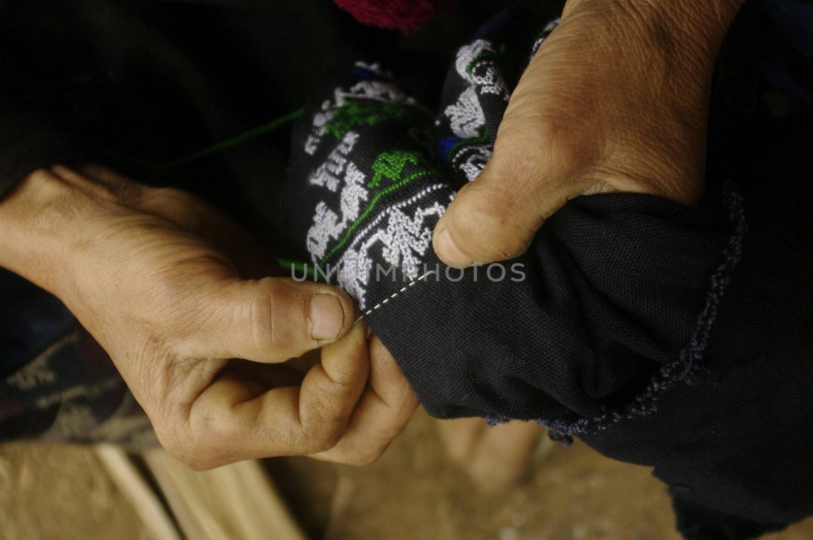 Dao tribe woman embroidering black pants. The reasons are rituals and art is always the same for centuries.