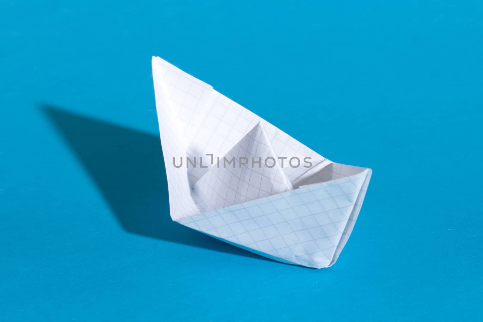 Paper ship, photo on the blue background