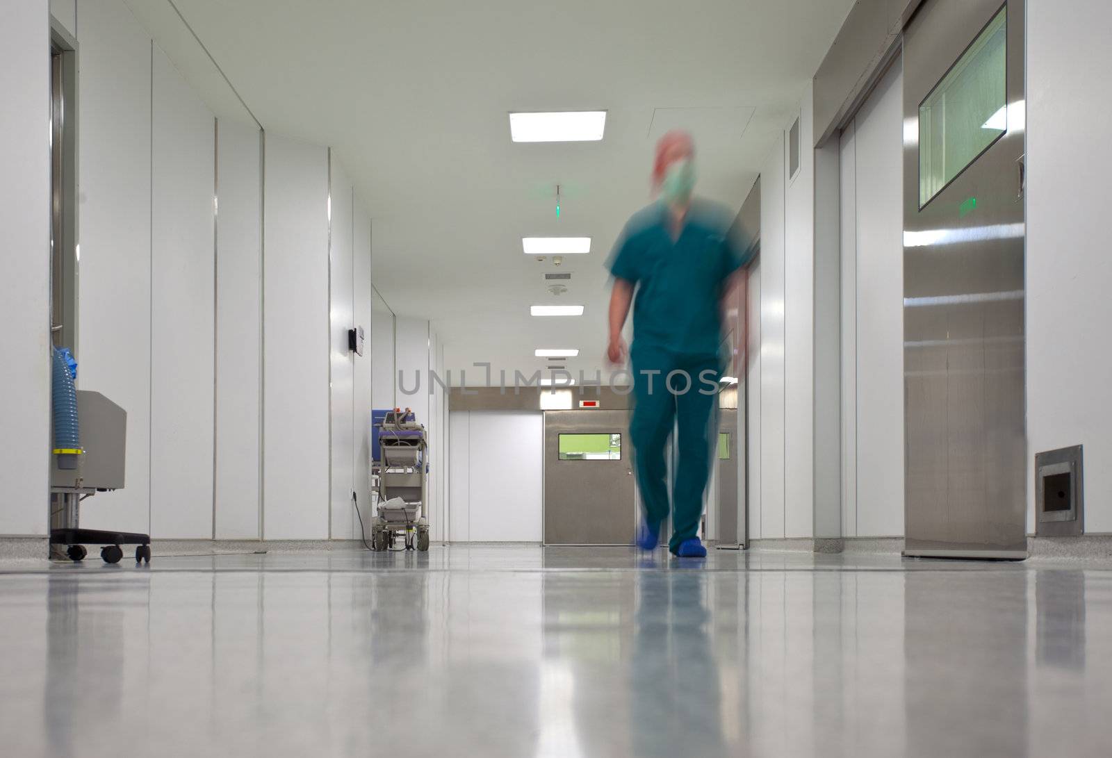 Blurred figure of doctor in hospital surgery corridor