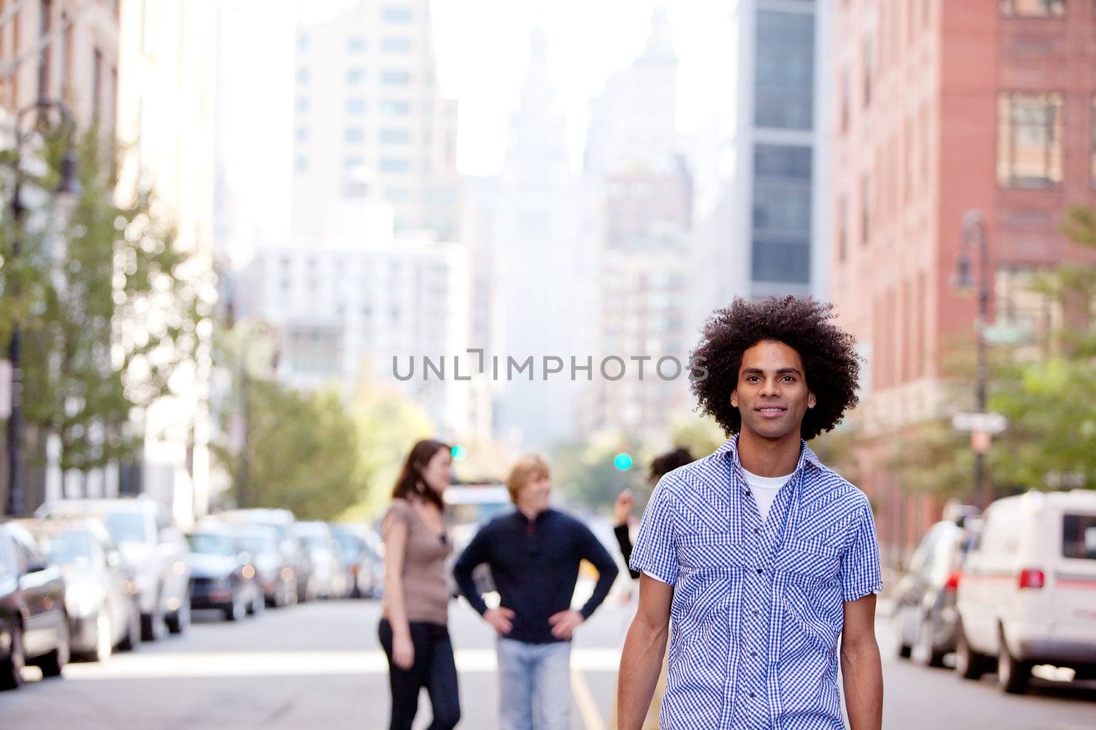 A city setting with a group of friends, a happy African American in the foreground