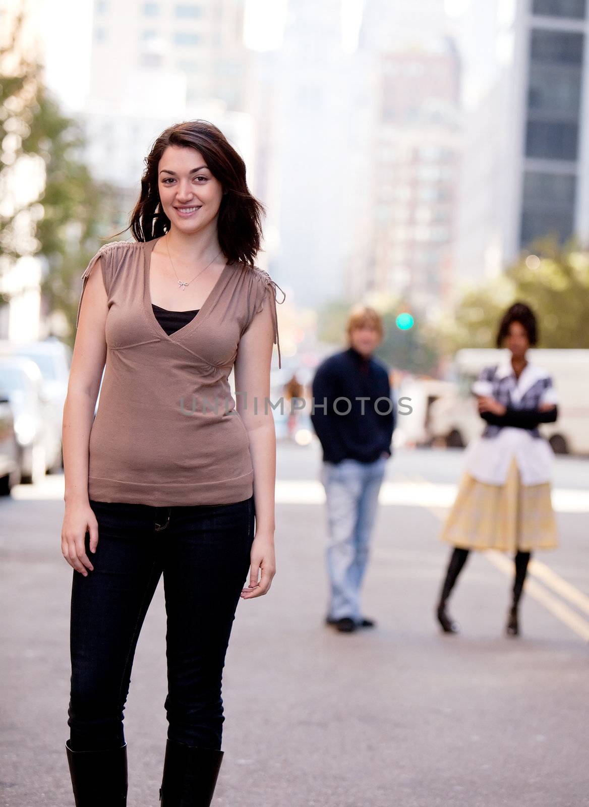 A young woman in a city setting with friends in the background