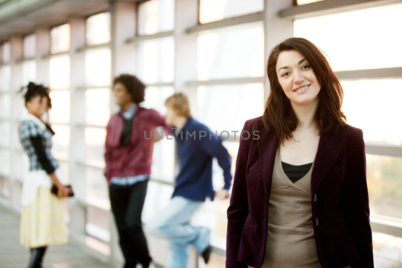 A portrait of a young woman with friends in the background