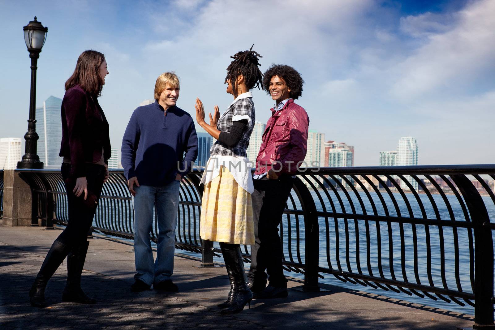 A group of friends on a city walk way by the water