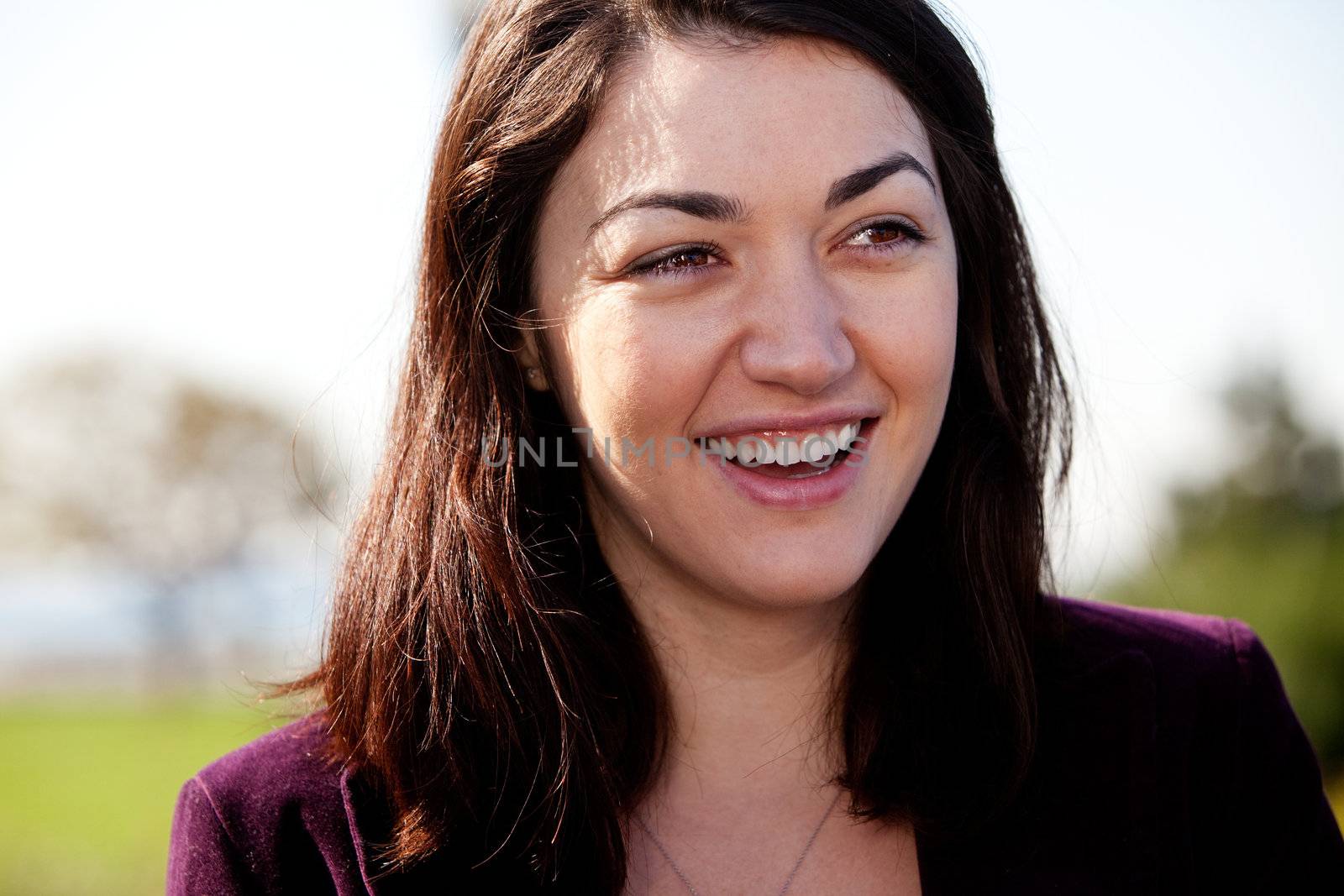 A candid portrait of a happy girl outside in a park