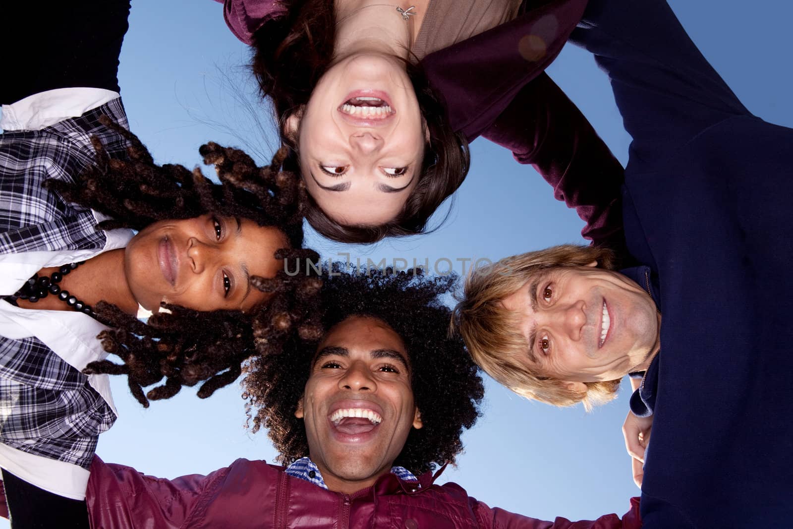 A group of friends in a huddle forming a circle