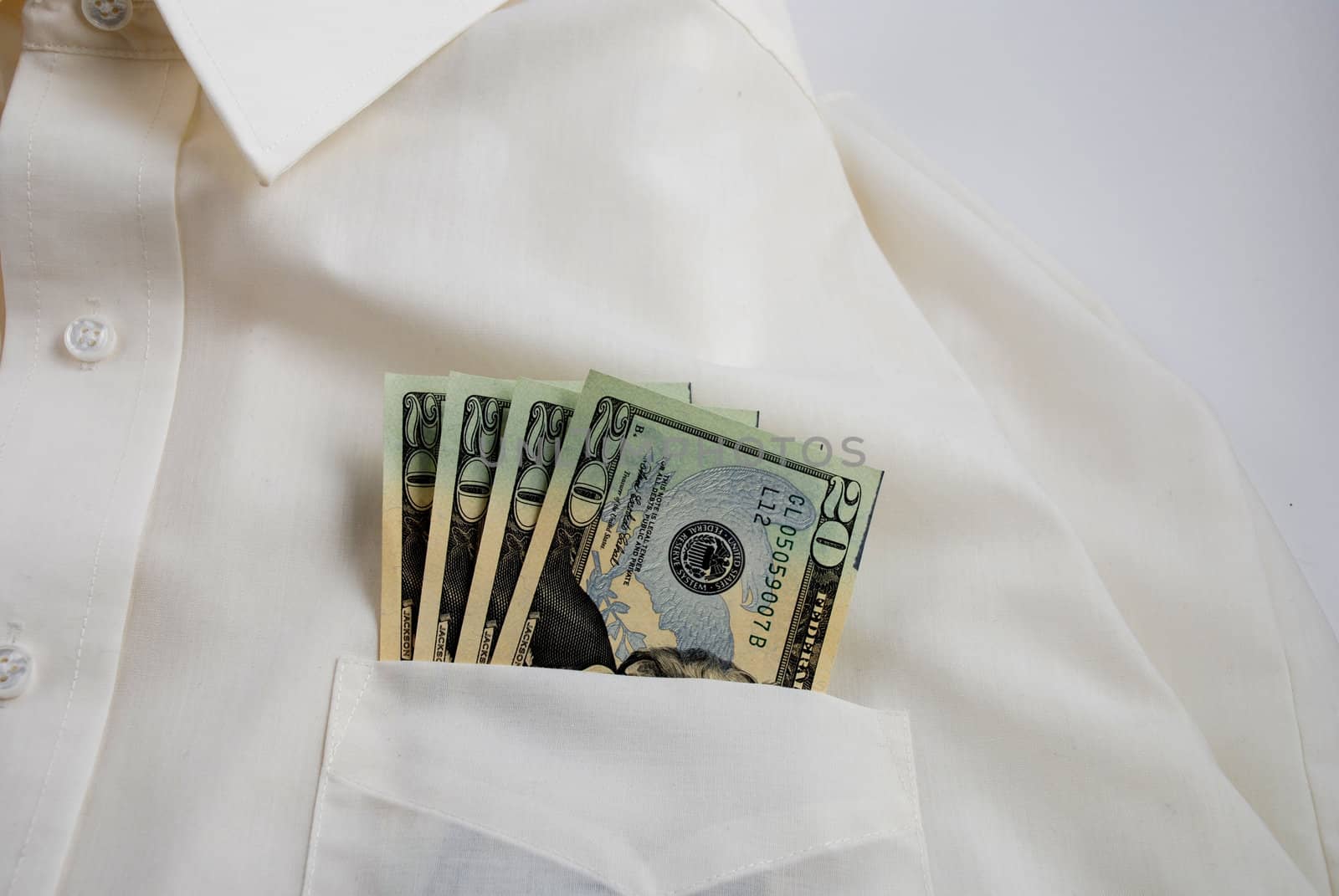  pictures of several twenty dollar bills in the pocket of a shirt