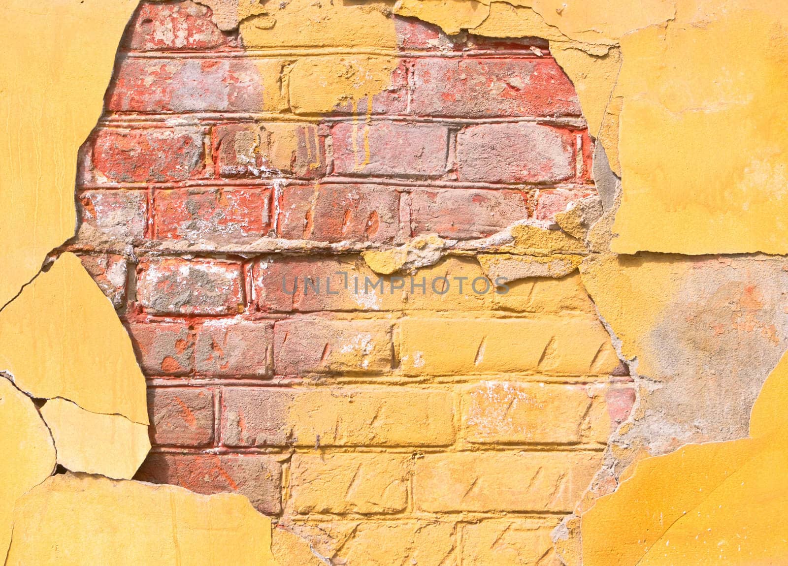 Flaked plaster on the  old brick wall, grunge background