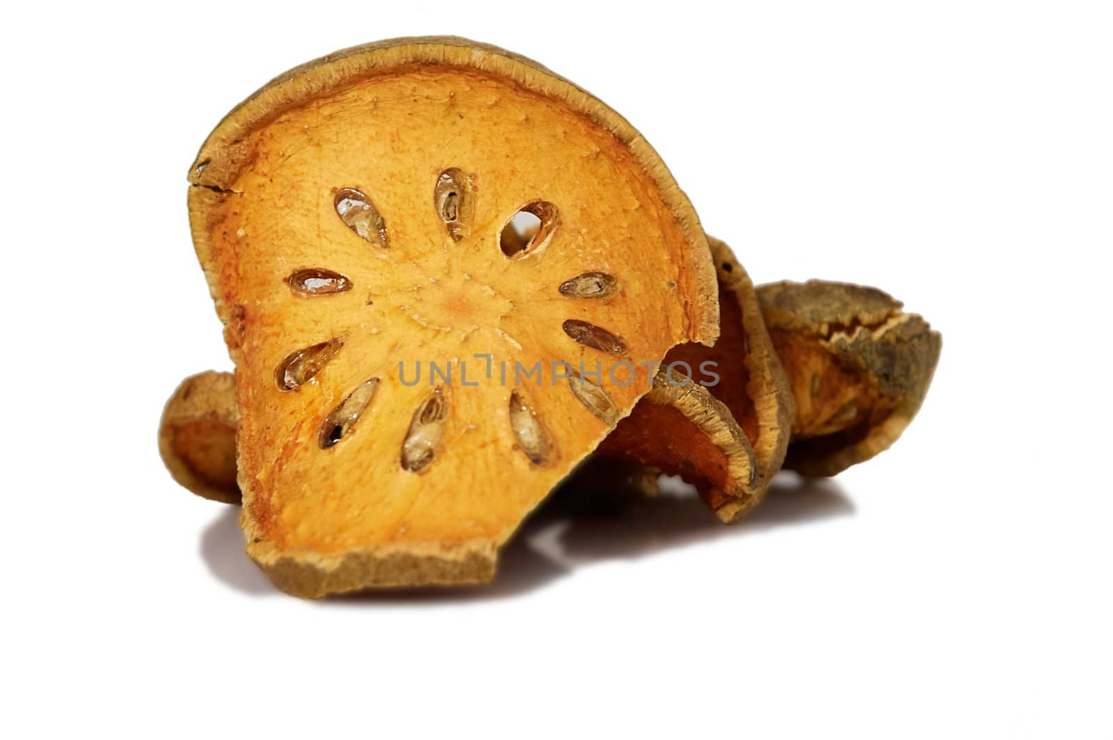 Bale Fruit dried tee. Isolated on white. Bale fruit is tropical fruit with hard exterior cover. The fruit has medicinal value for digestive system. Extensively consumed in rural India and Thailand.