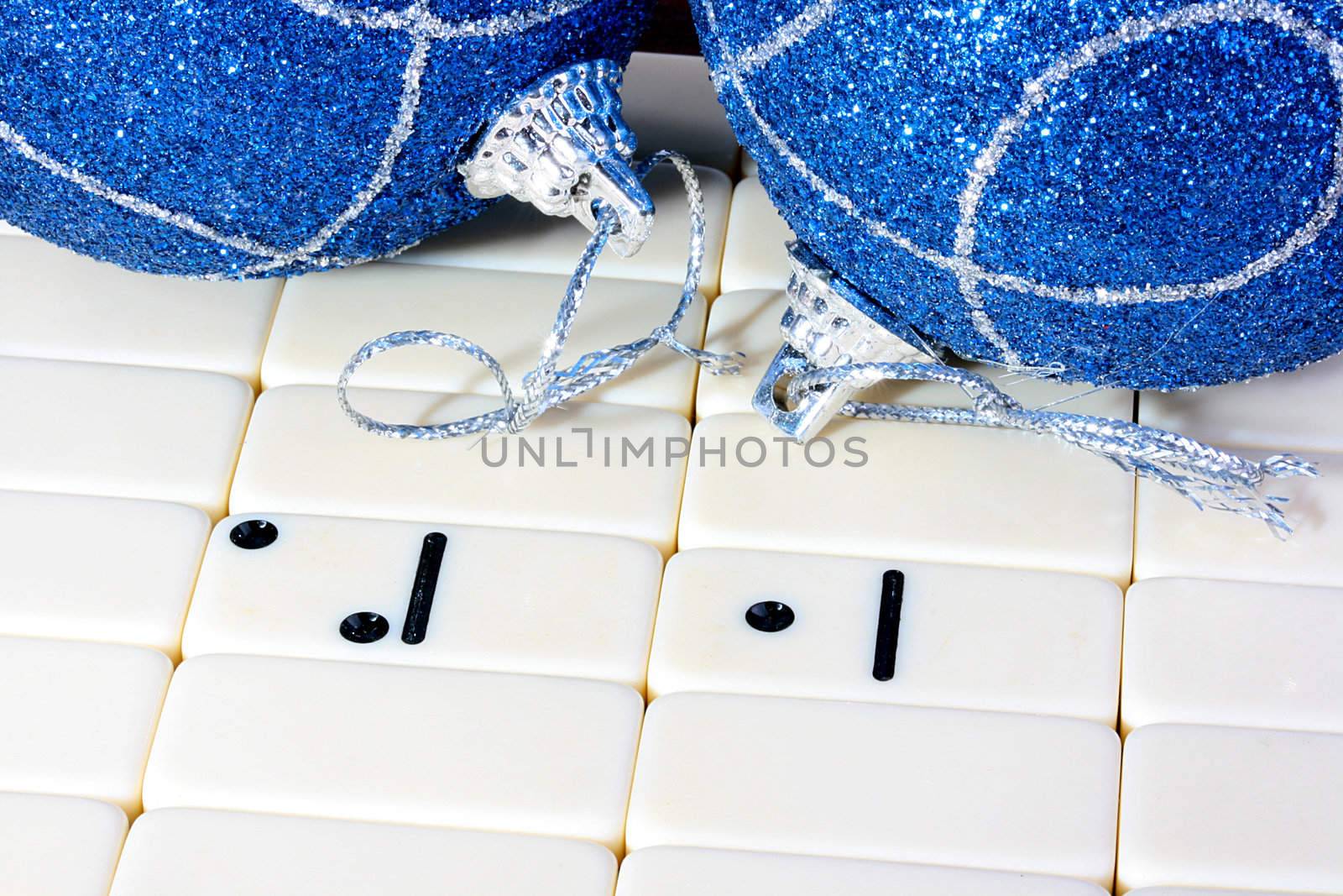 The dominoes, all counters are turned except two which create number 2010. On a back background two dark blue fur-tree spheres. A photo by new 2010.