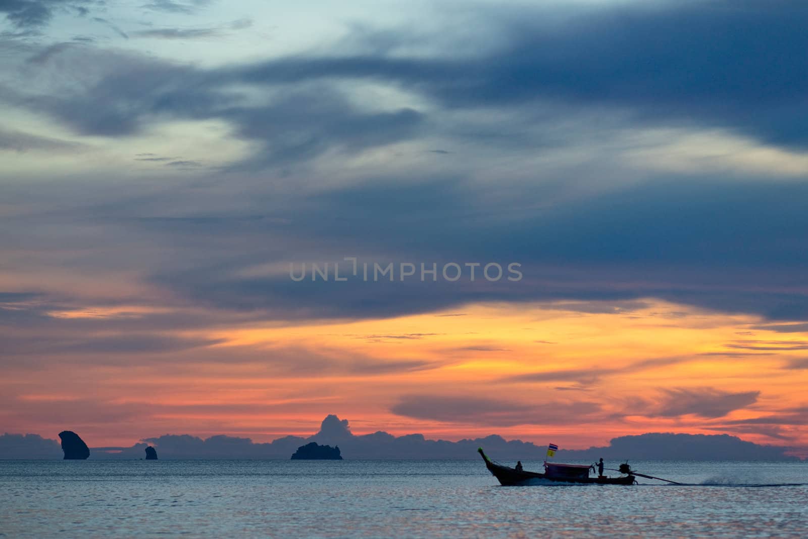 Silhouette of a boat in the sea at sunset