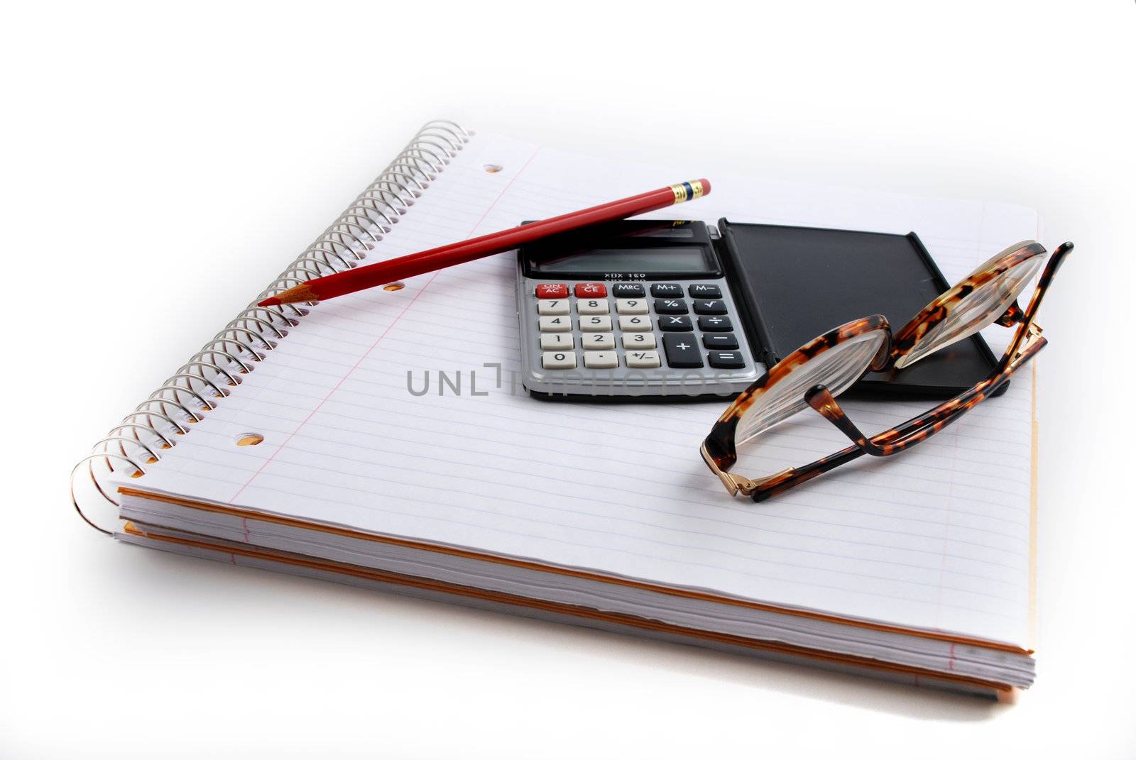 Pictures of a calculator and glasses resting on a notepad, ready to do calculations