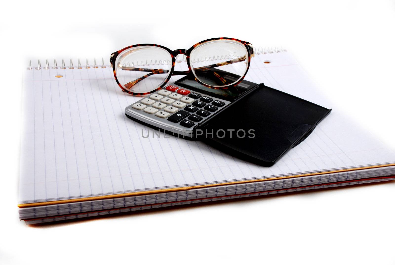 Pictures of a calculator and glasses resting on a notepad, ready to do calculations