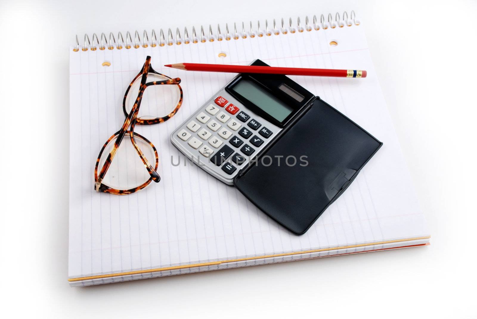 Pictures of a calculator and glasses resting on a notepad, ready to do calculations