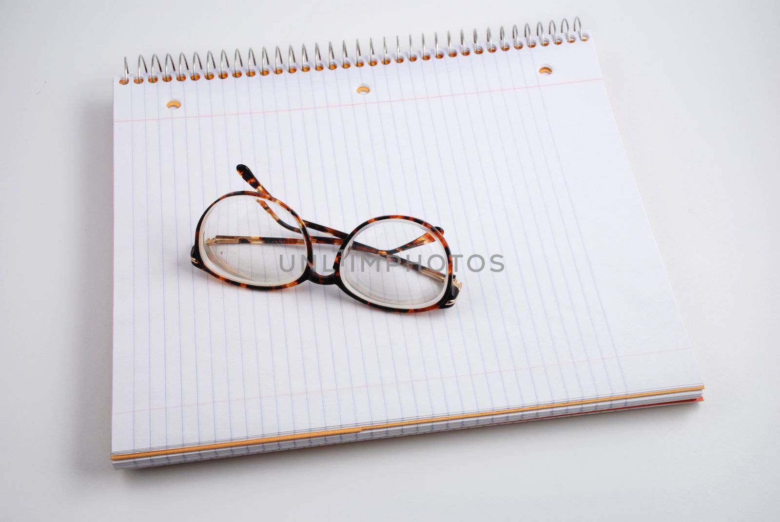 Pictures of glasses resting on a notepad, indicating the writer is taking a break from thinking