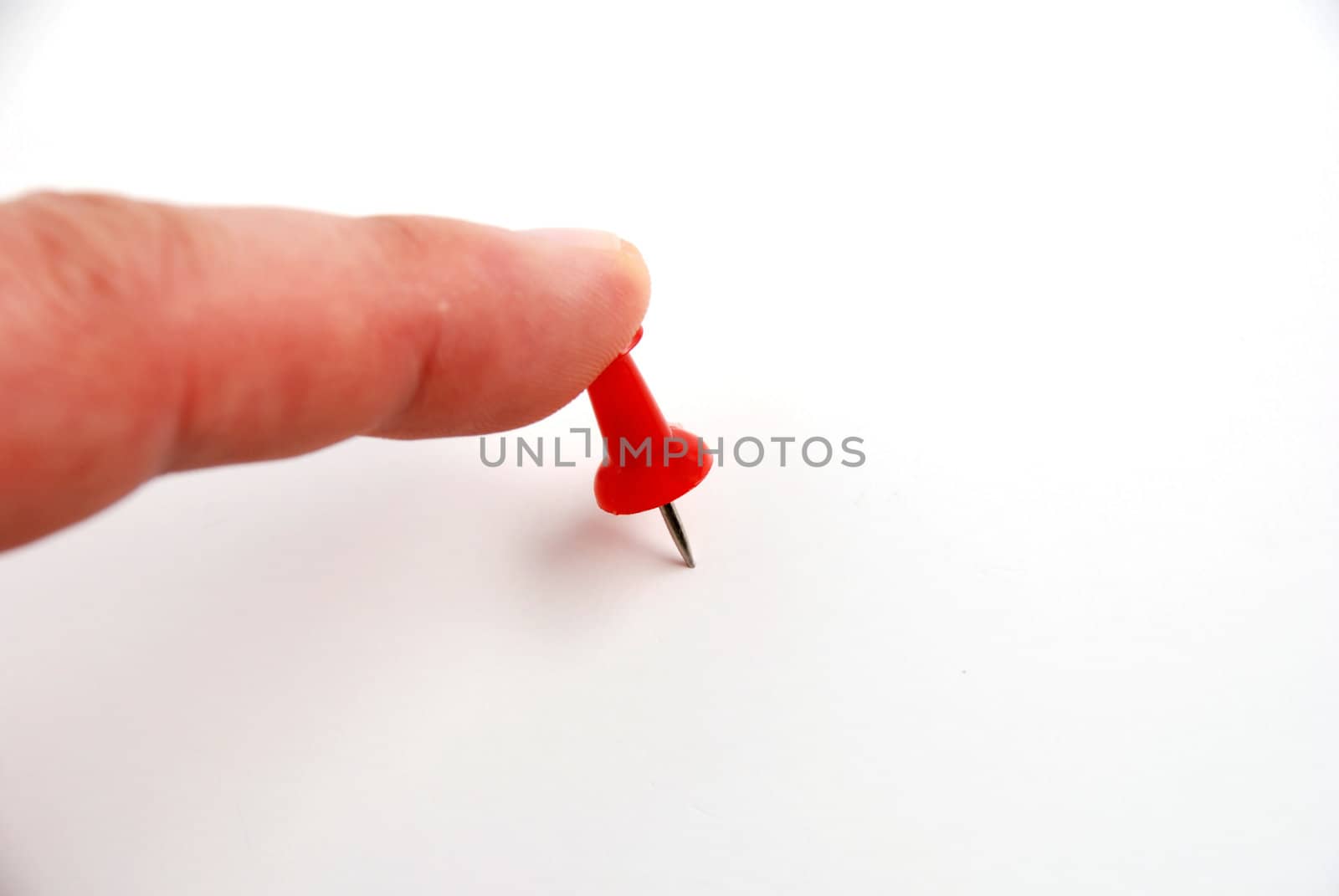 Stock pictures of a red push pin on white background paper