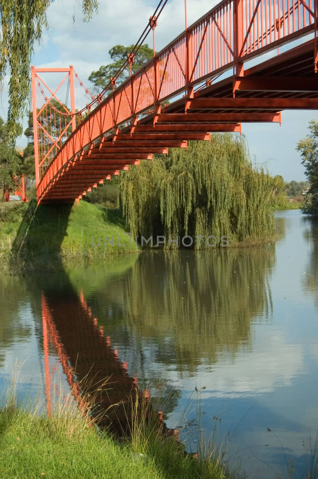 A Colourful Scenic Red Bridge over a River Photo