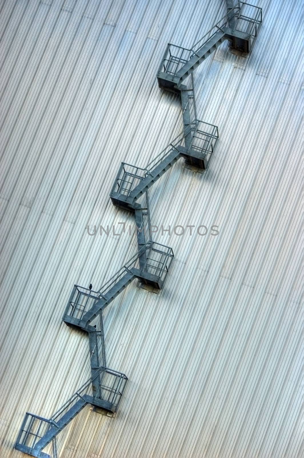 A Metalic Industrial Photo of a Ladder from a Hanger