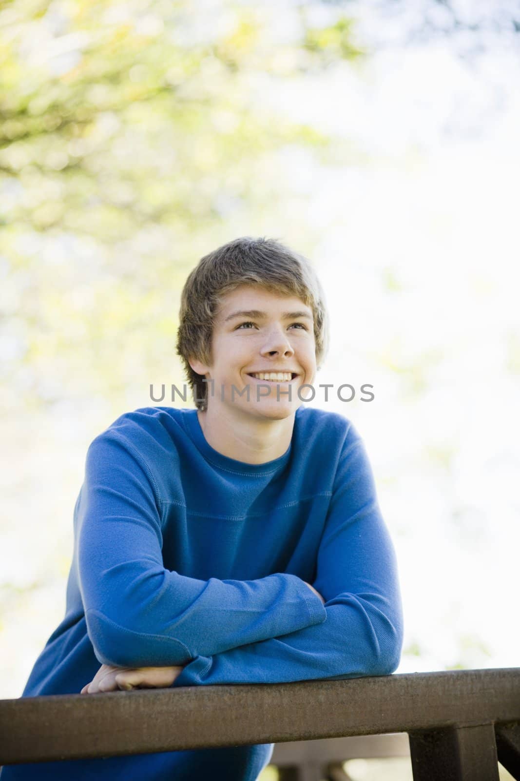 Portrait of a Smiling Teenage Boy Leaning on Railing
