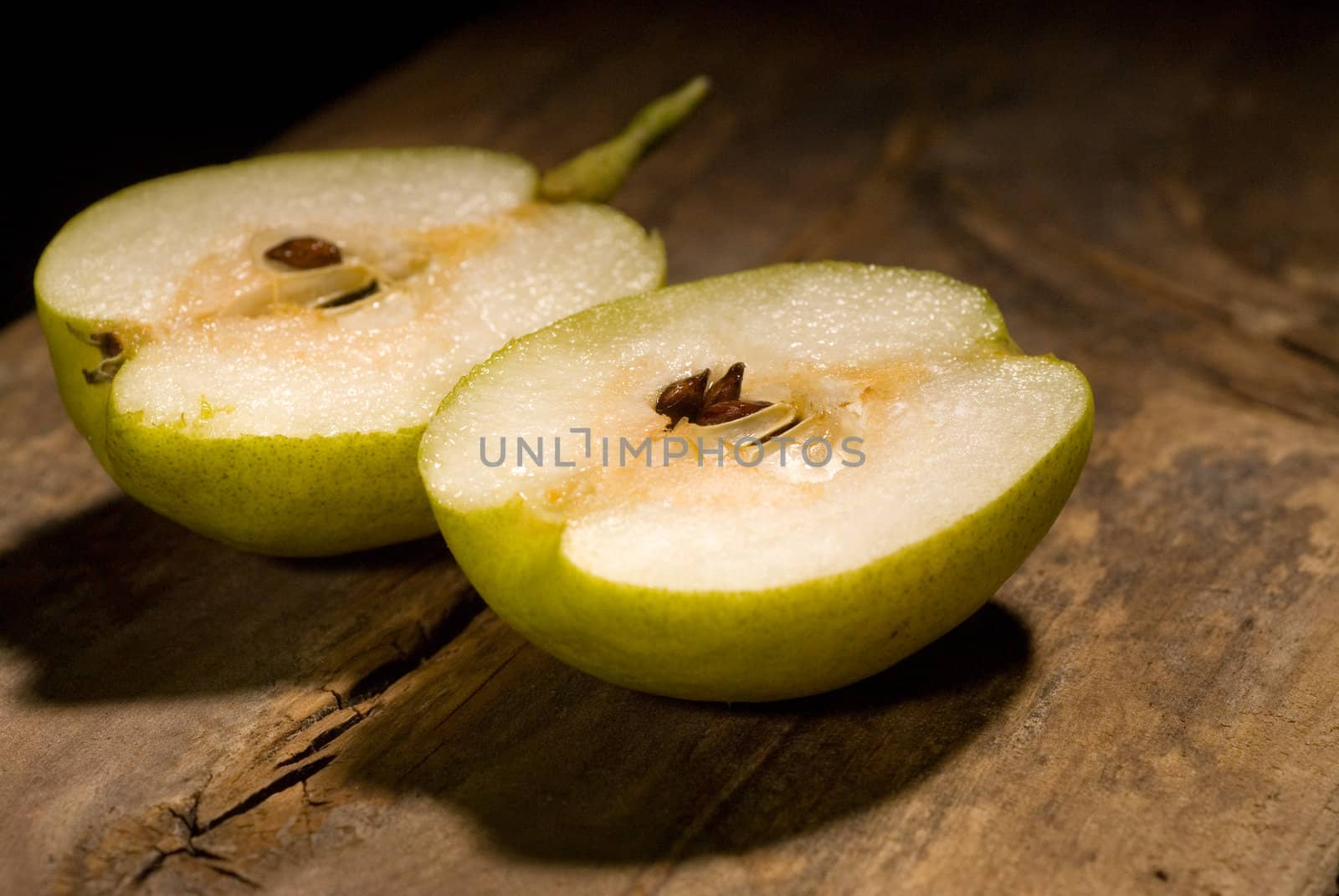 autumn fresh pears cutted  in half over old wood board