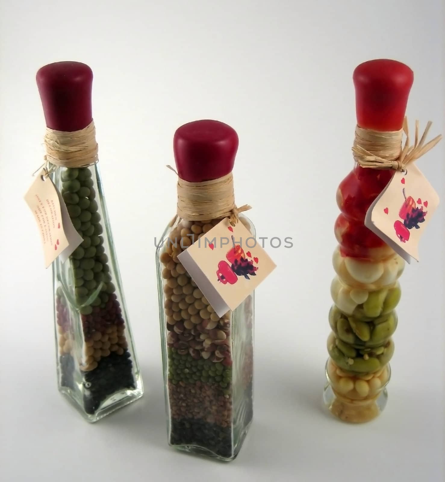 Bottles with oil and legumes inside used for decorative purposes in kitchens