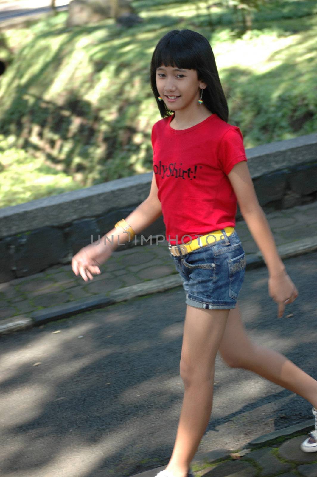 cute asian girl walking in the park