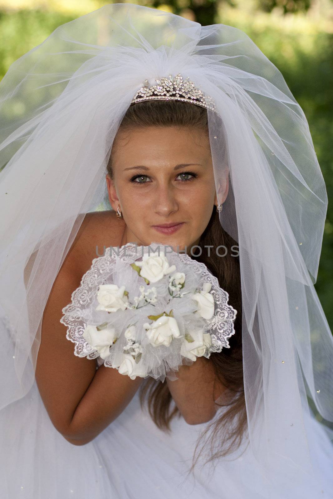 The bride with a bouquet of white flowers