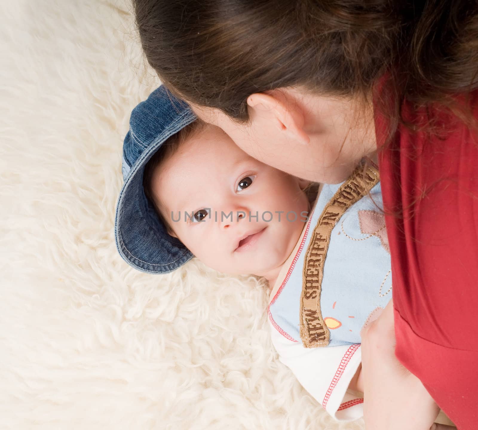 Shot of trendy newborn boy in denim cap