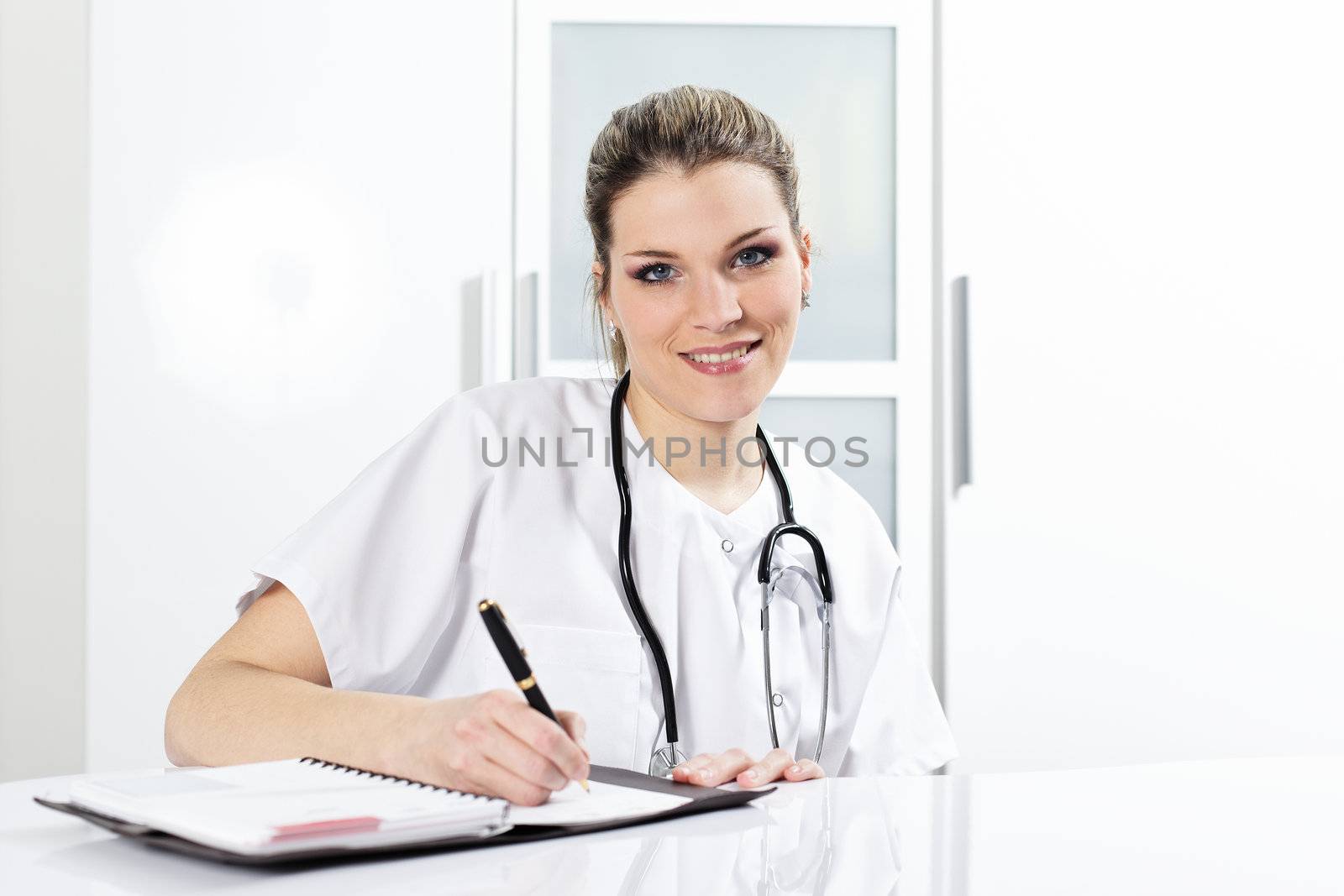 woman doctor with pen and stethoscope in hospital