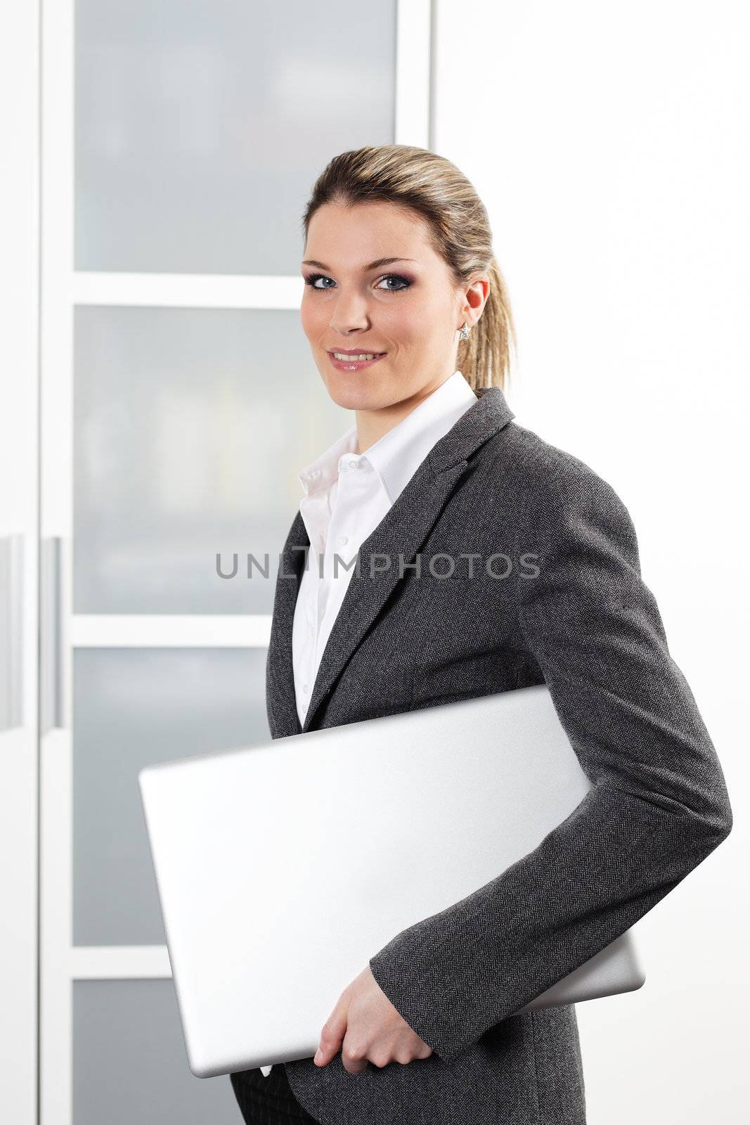 young beautiful woman with laptop in office