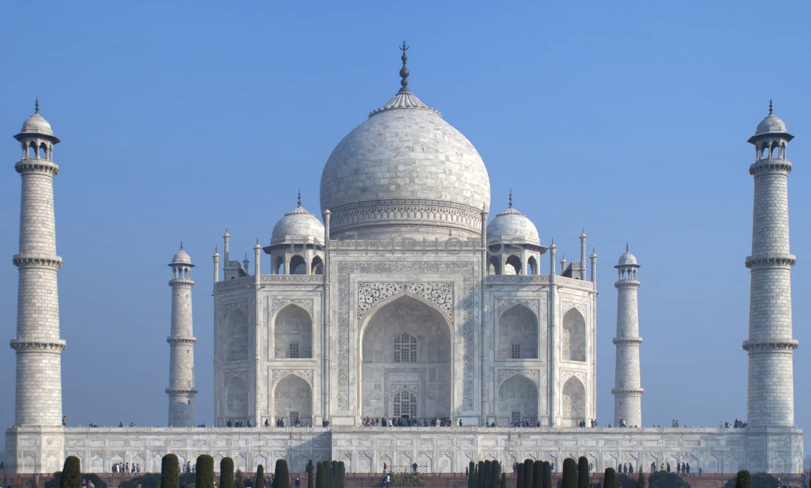 The white marble Taj Mahal mausoleum as a block against blue ski by Claudine