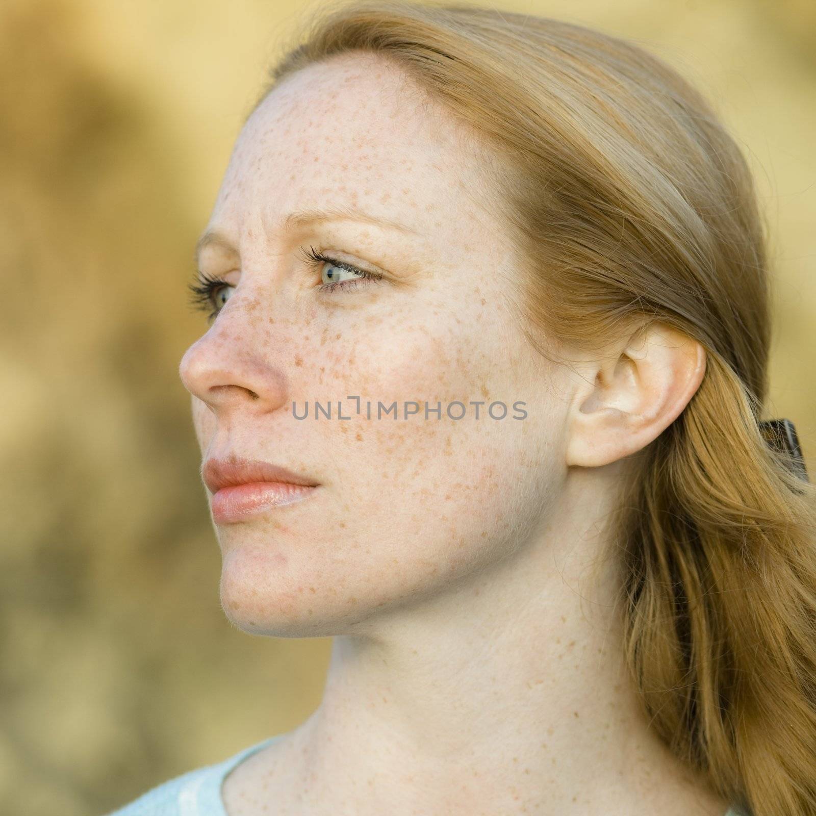 Portrait of a Pretty Redhead Woman Outdoors