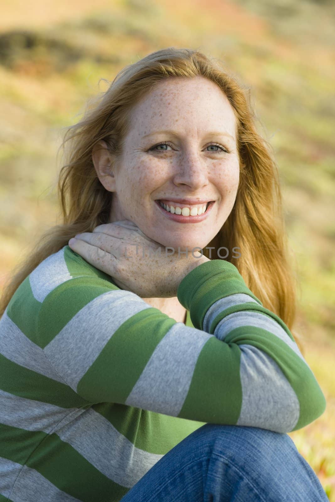 Portrait of a Pretty Redhead Woman Smiling To Camera