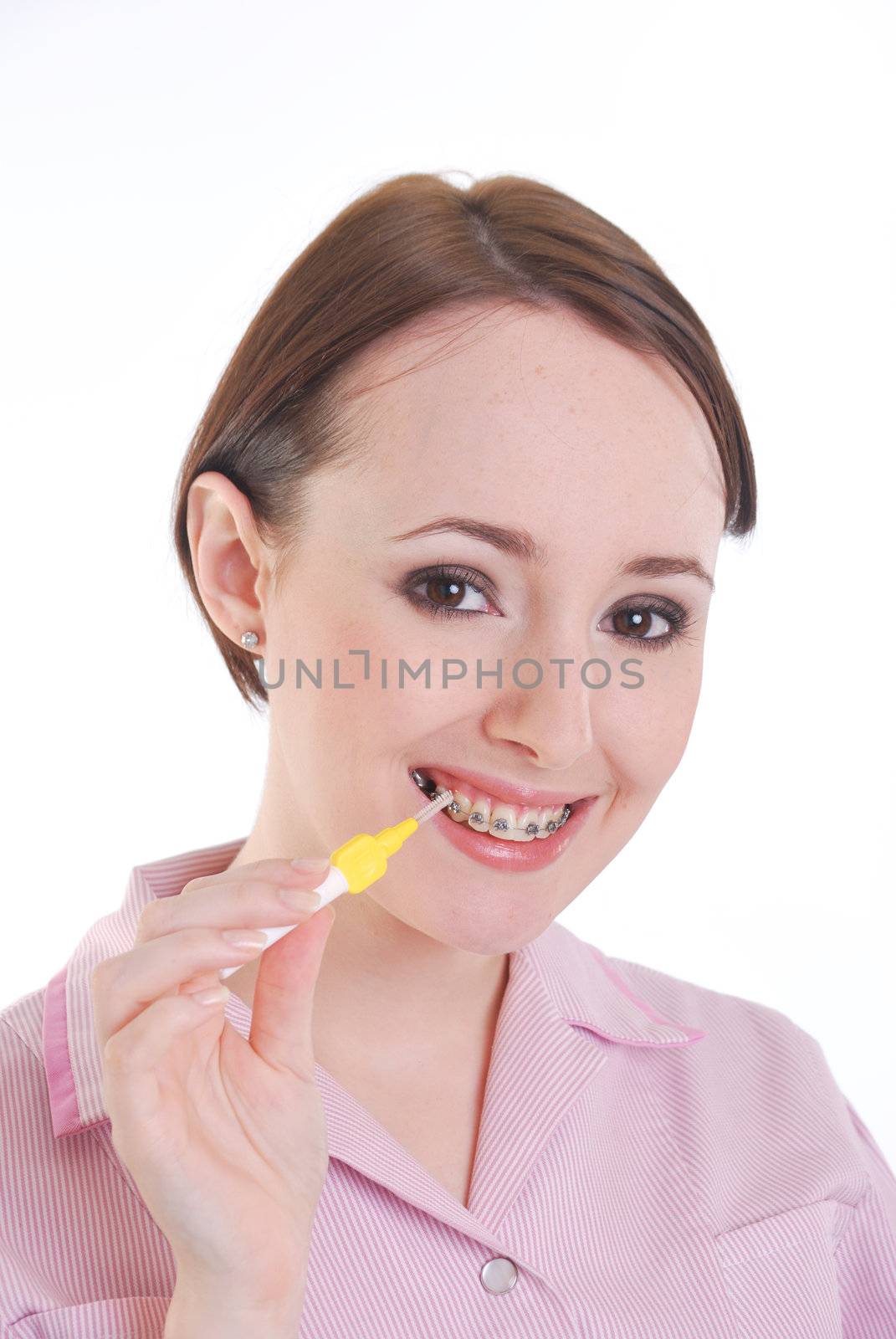 pretty girl with brace cleaning teeth