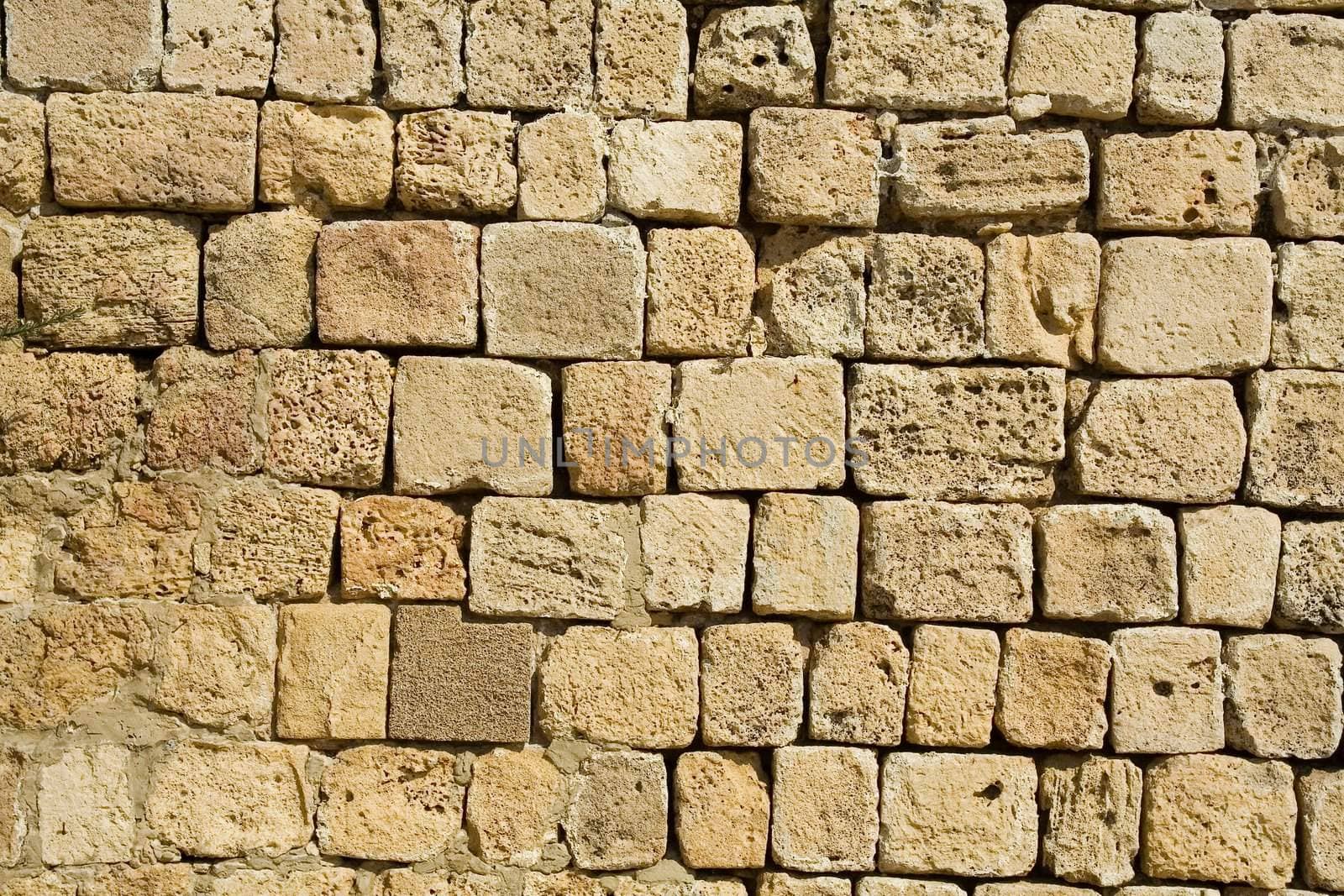 Wall constructed of stone bricks. A fine textural background for graphic design