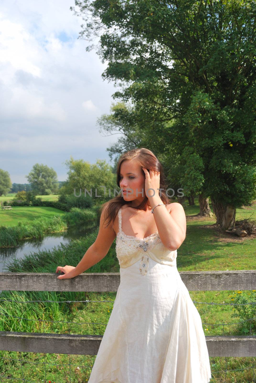 pretty girl standing by fence