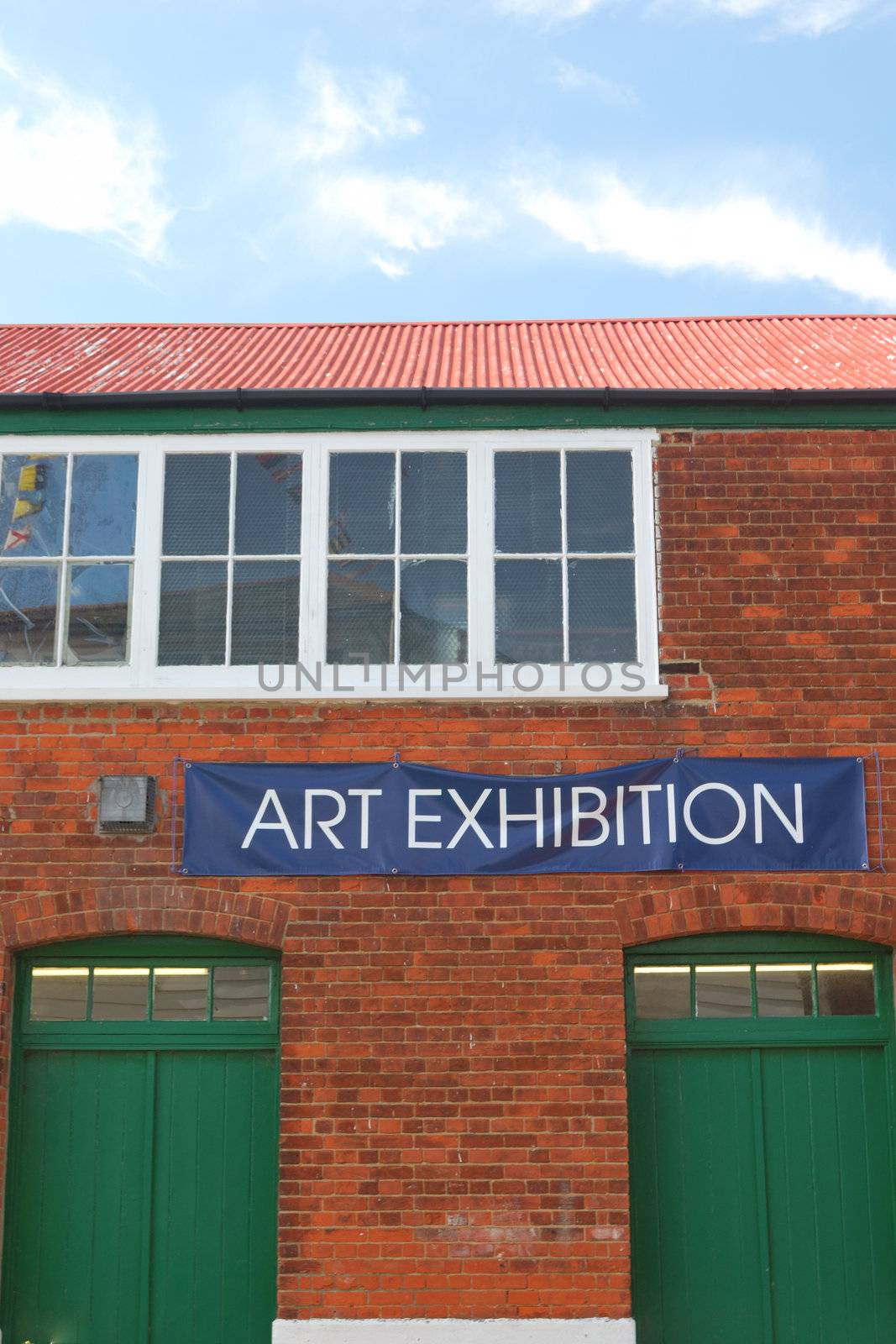 Art exhibition sign with brick building