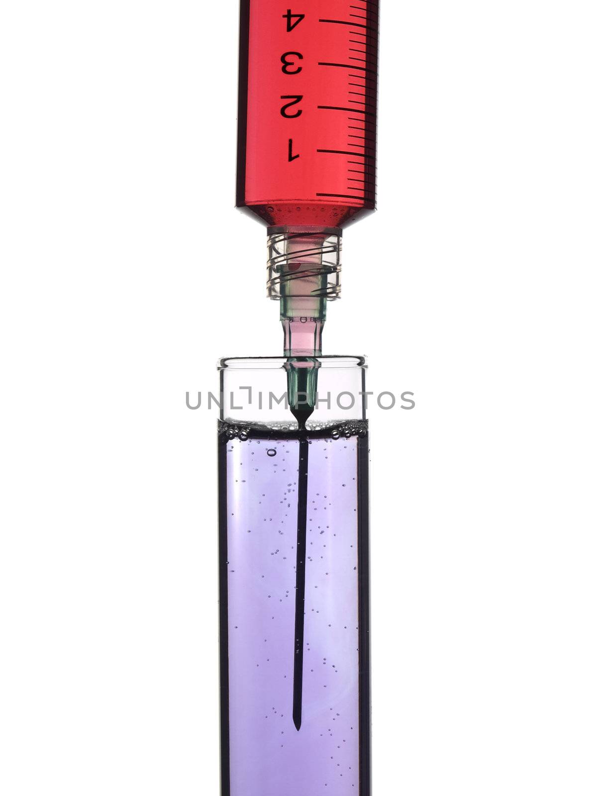 Syringe drooping sample on a test tube. Isolated on white.