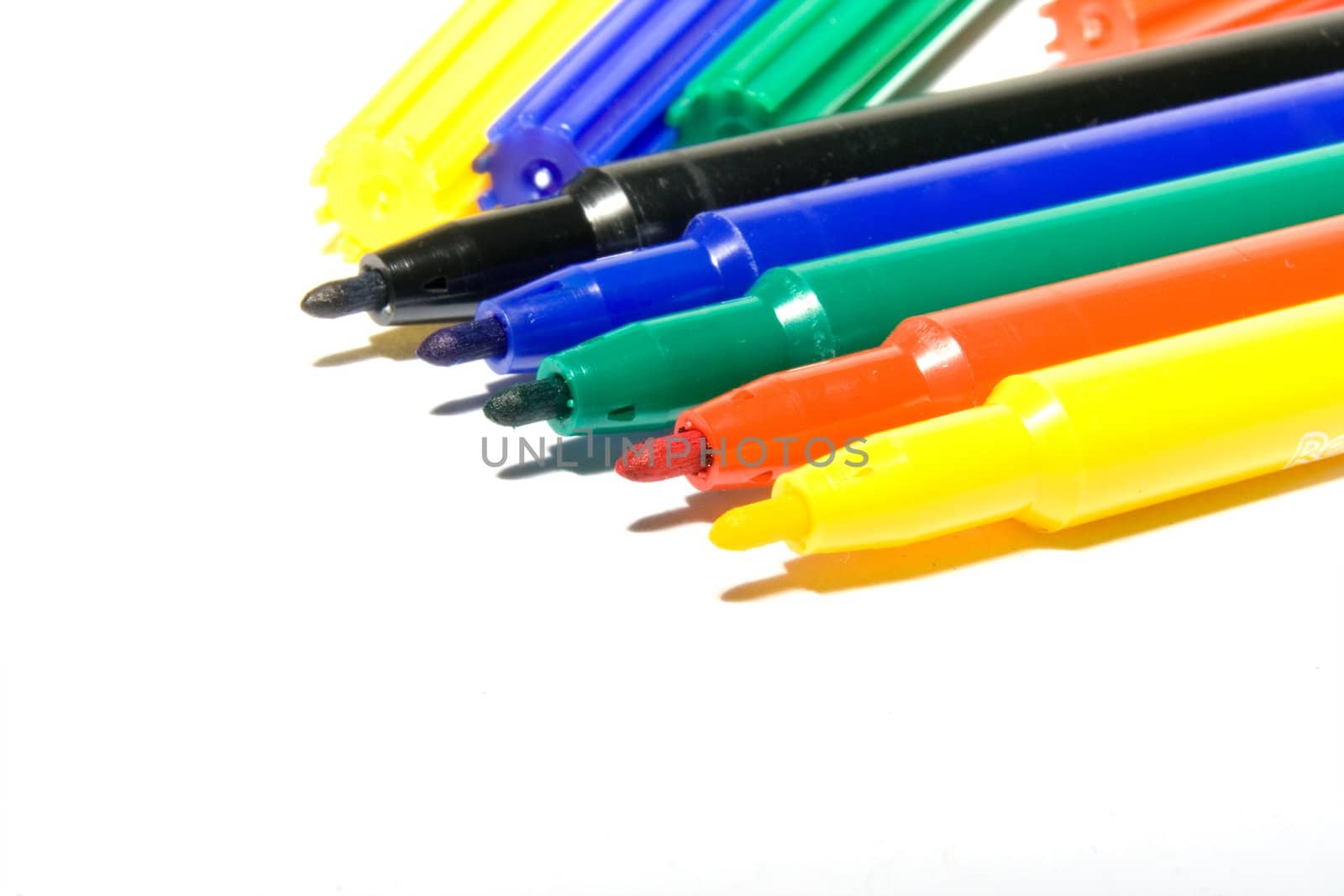 Color felt-tip pens photographed close up on a white background