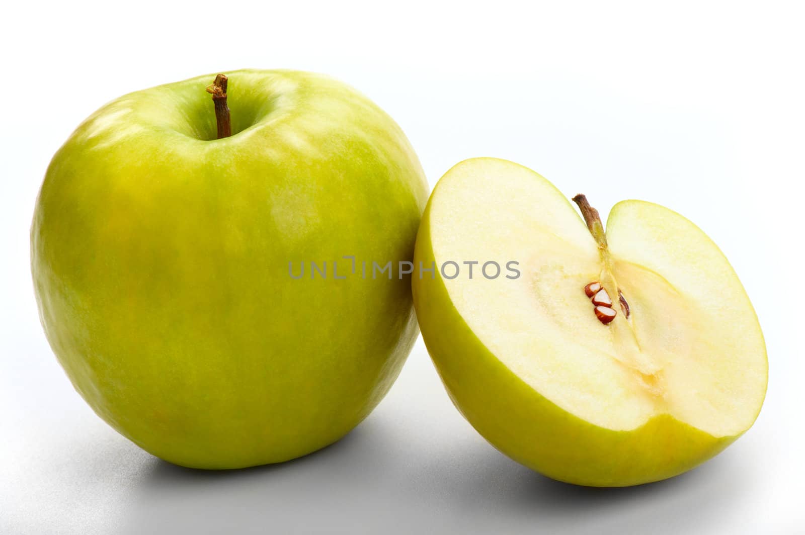 The ripe apples - whole and cut in half. A close up