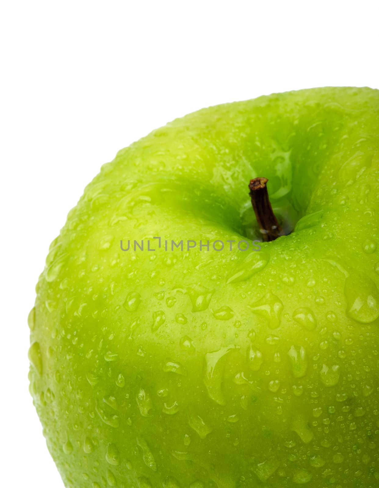 Green apple with water drops. Close-up