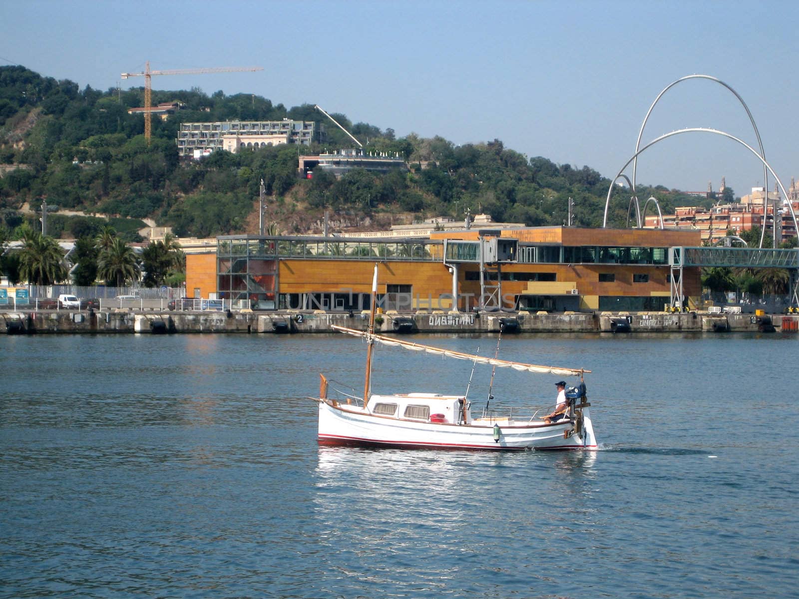 Several pictures of boats and sailboats in the harbor