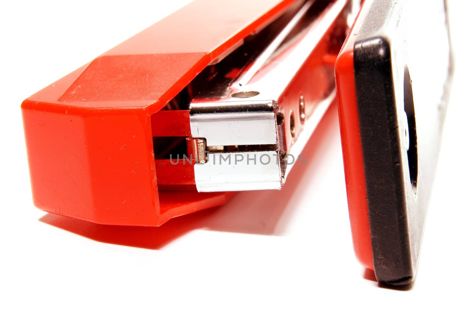 Working part of a stapler photographed close up on a white background