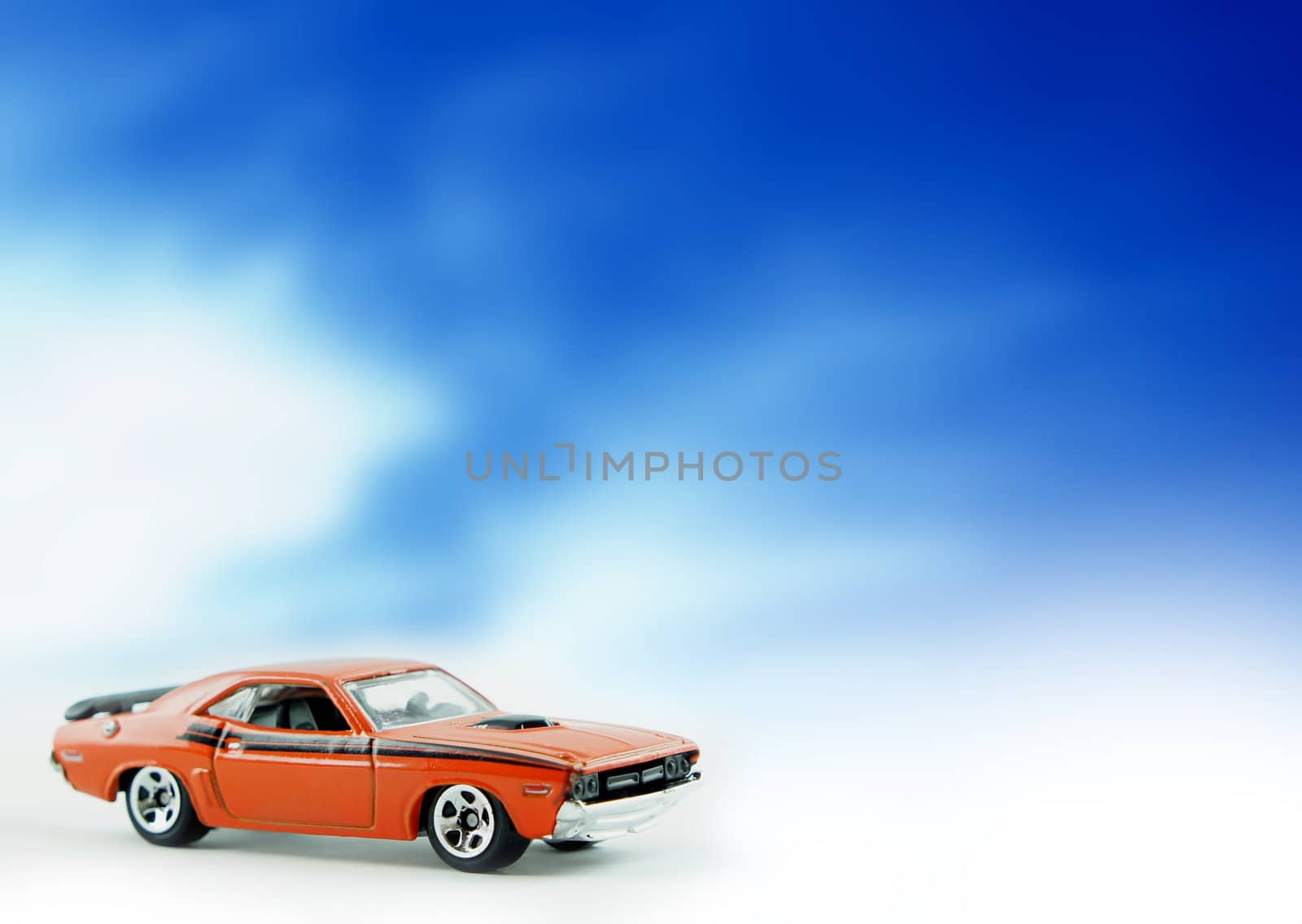 Dodge Challenger replica car on cloud background.