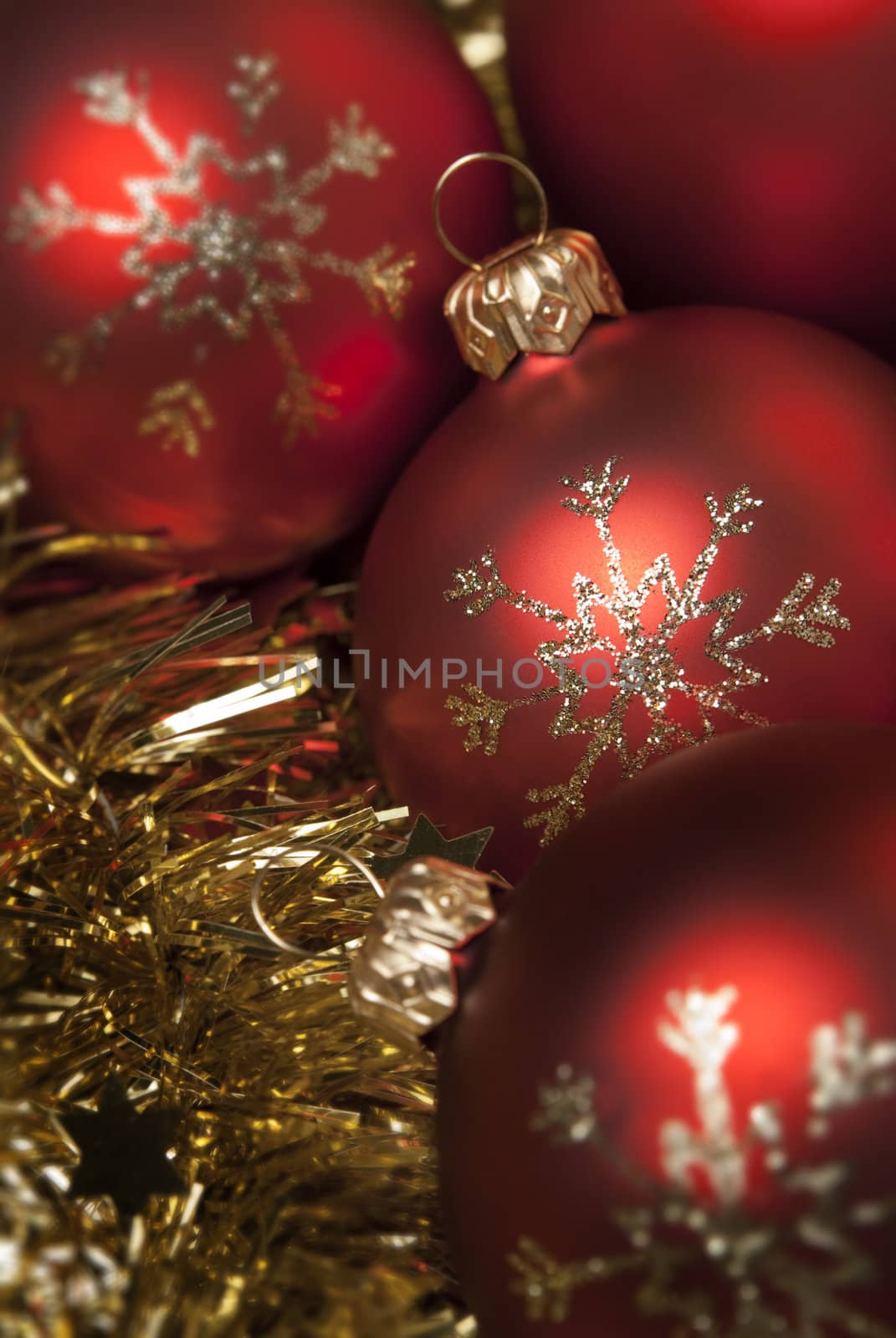 Red christmas ball on the gold tinsel. aRGB.